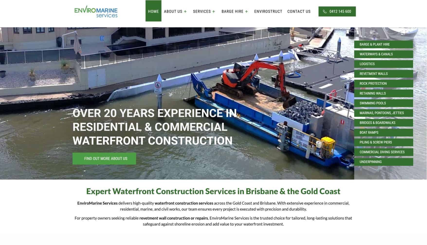 Waterfront construction with heavy machinery and boats at a dock.