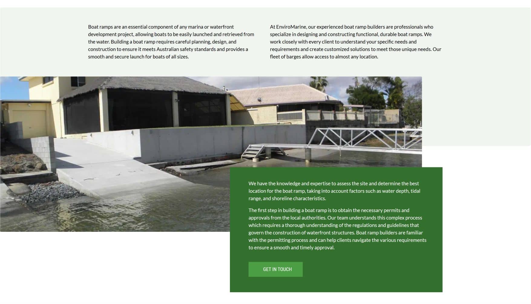 Boat ramps at a marina with a dock and water, used for watercraft access.